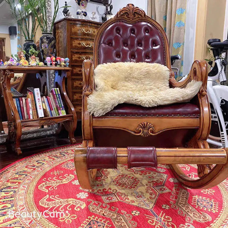 Vintage round rug in red tones under a classic wooden armchair