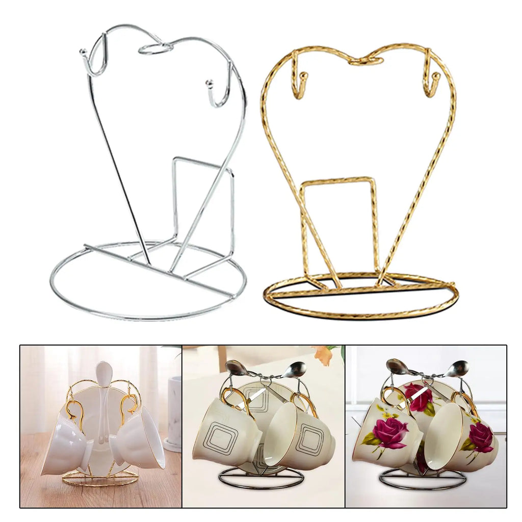 two heart-shaped metal mug holder stands side by side, silver and gold, on white