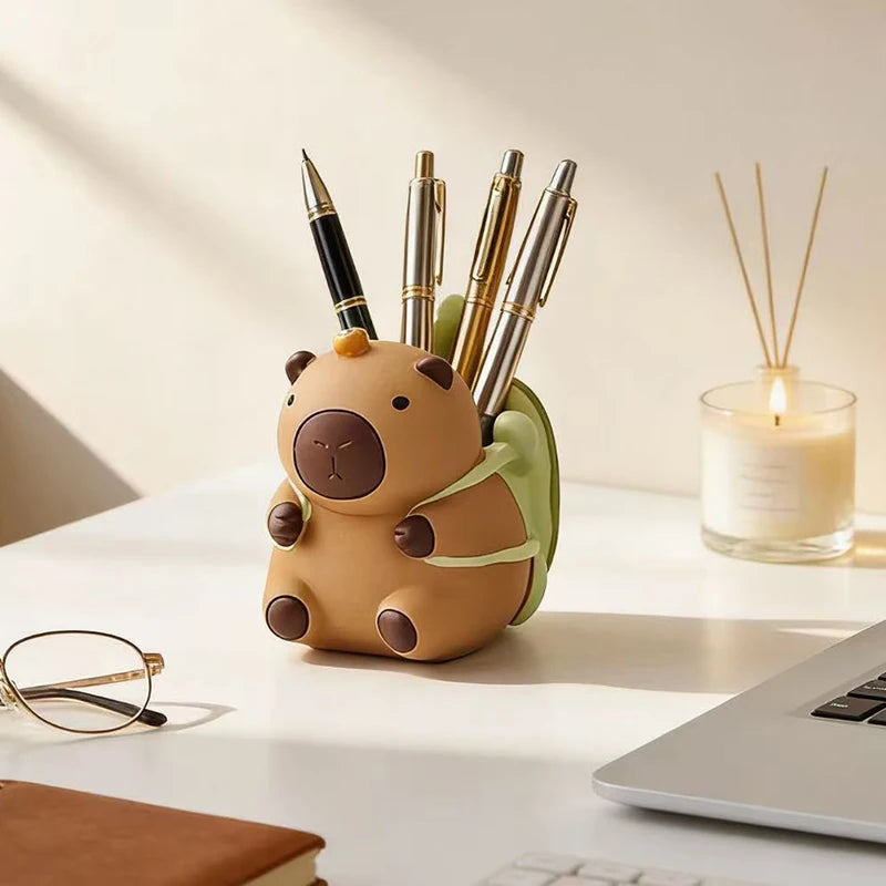 Resin animal pen holder with gold pens in a cozy workspace