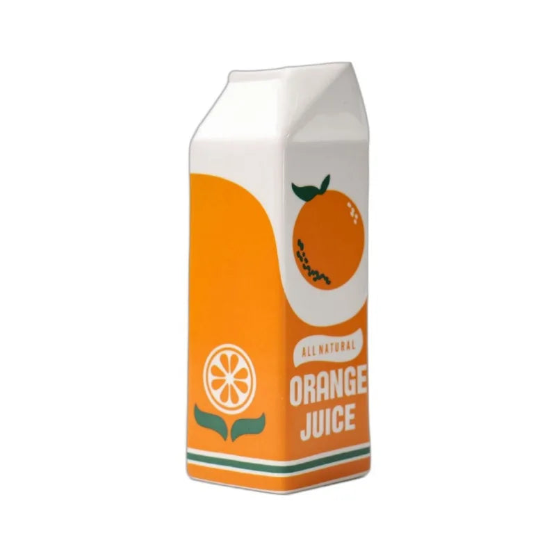 Ceramic orange juice carton-shaped vase with orange and white print, empty and upright