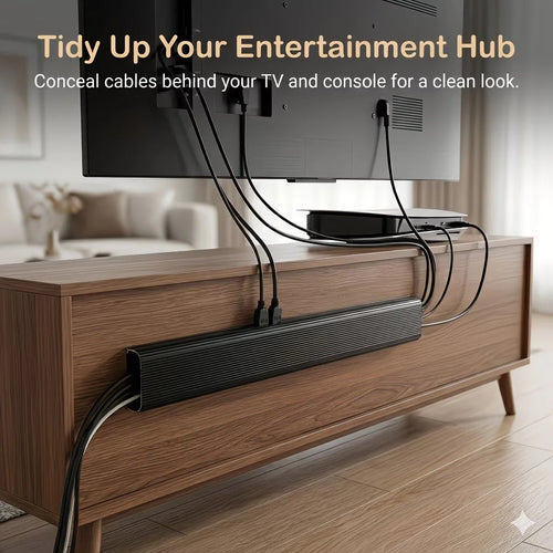 Black adhesive cable organizer tray concealing cords behind a TV on a wooden console in a living room
