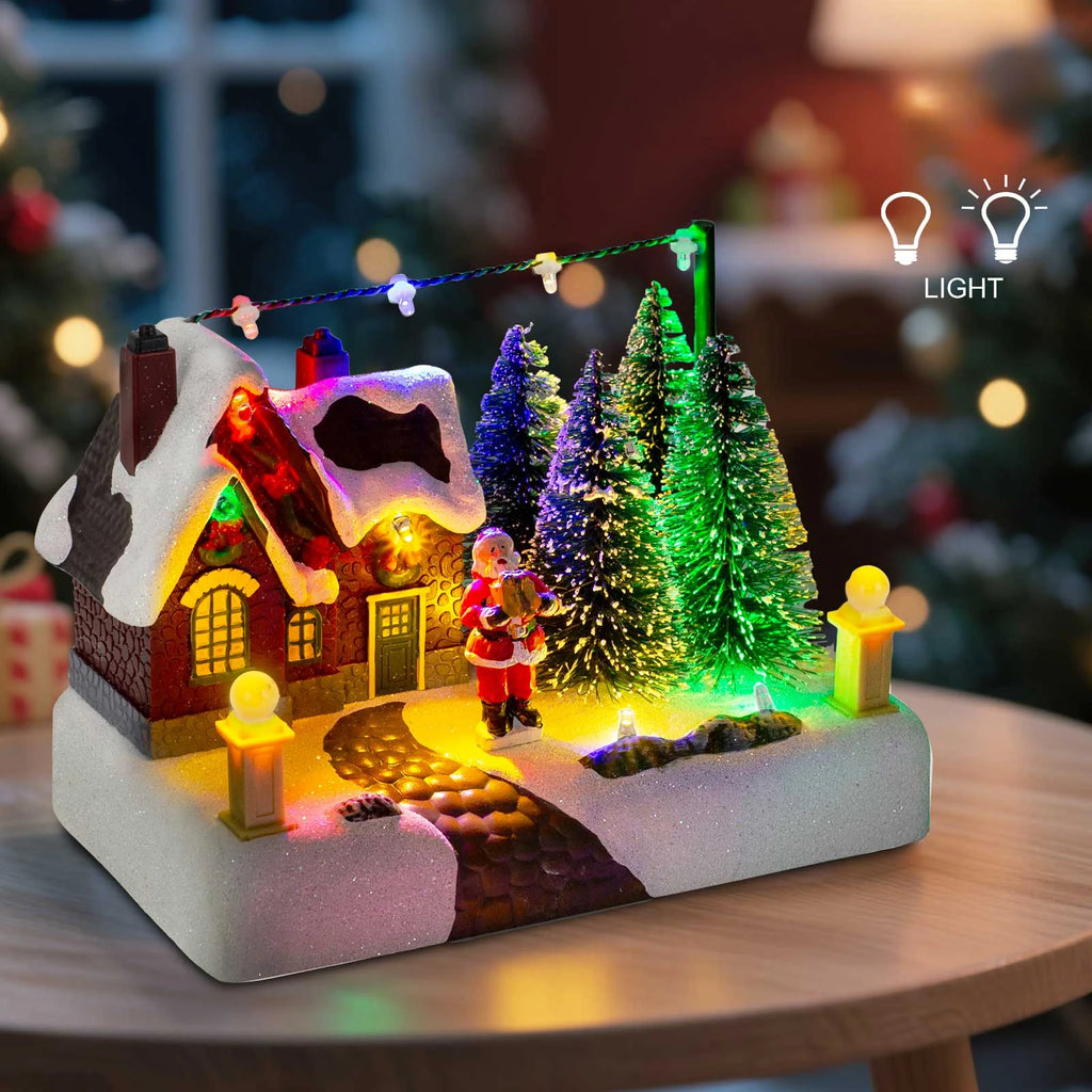 LED Christmas village house scene illuminated on table in festive living room