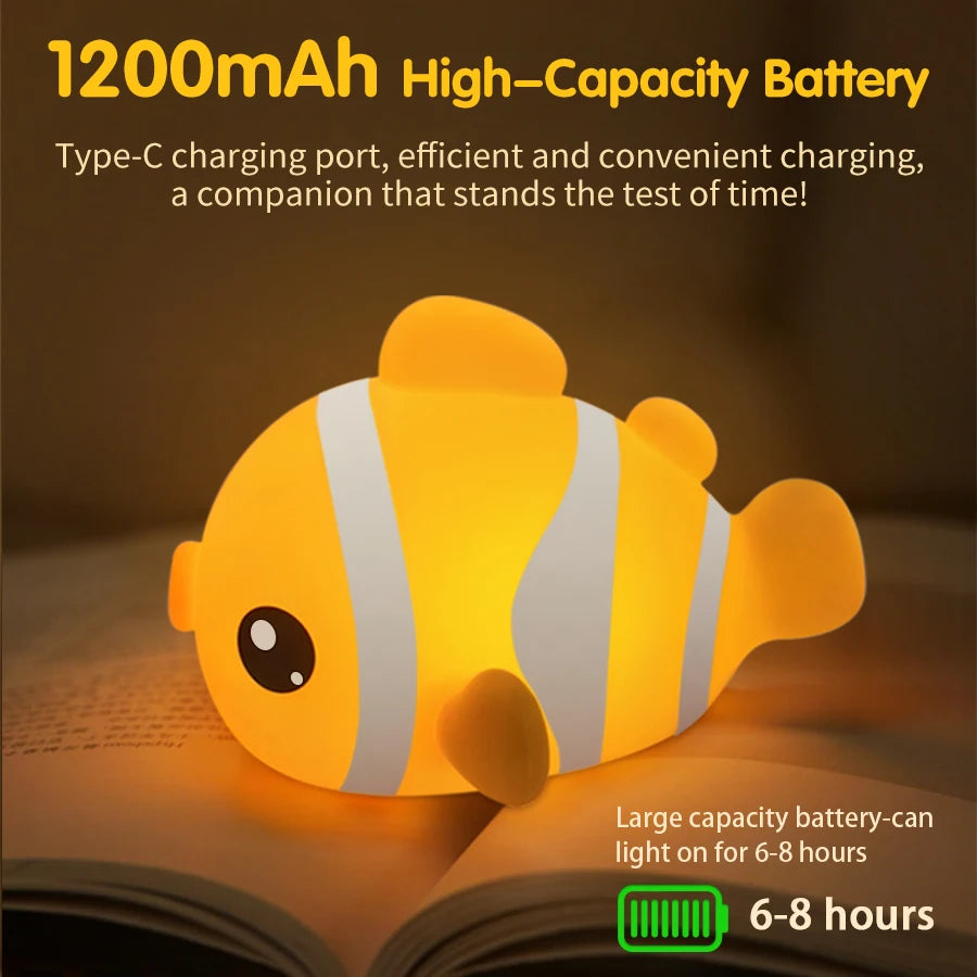 Clownfish silicone night light on a book, showing battery life information