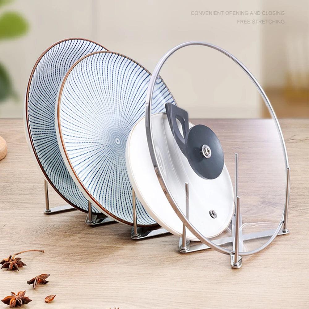 Retractable stainless steel rack organizing plates and pot lids upright on a counter