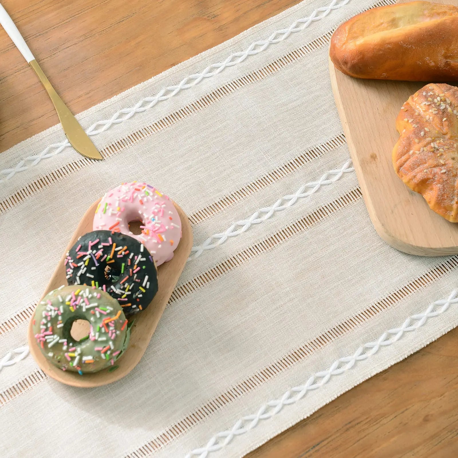 ivory linen table runner on dining table set for breakfast with pastries