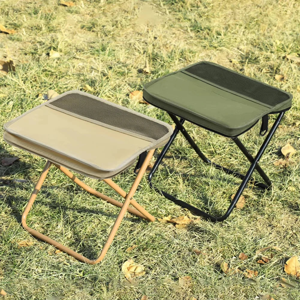 Khaki and green folding backpack stools set up on outdoor grass