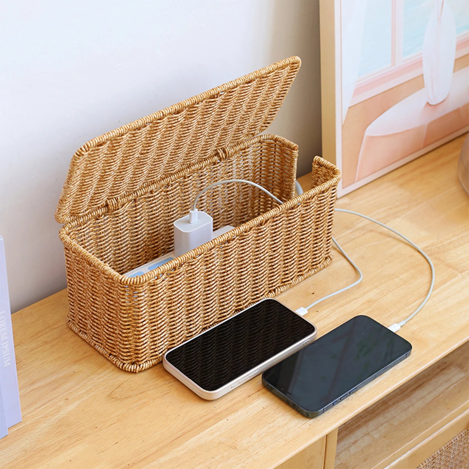 Woven cable storage box on desk hiding phone chargers and cords