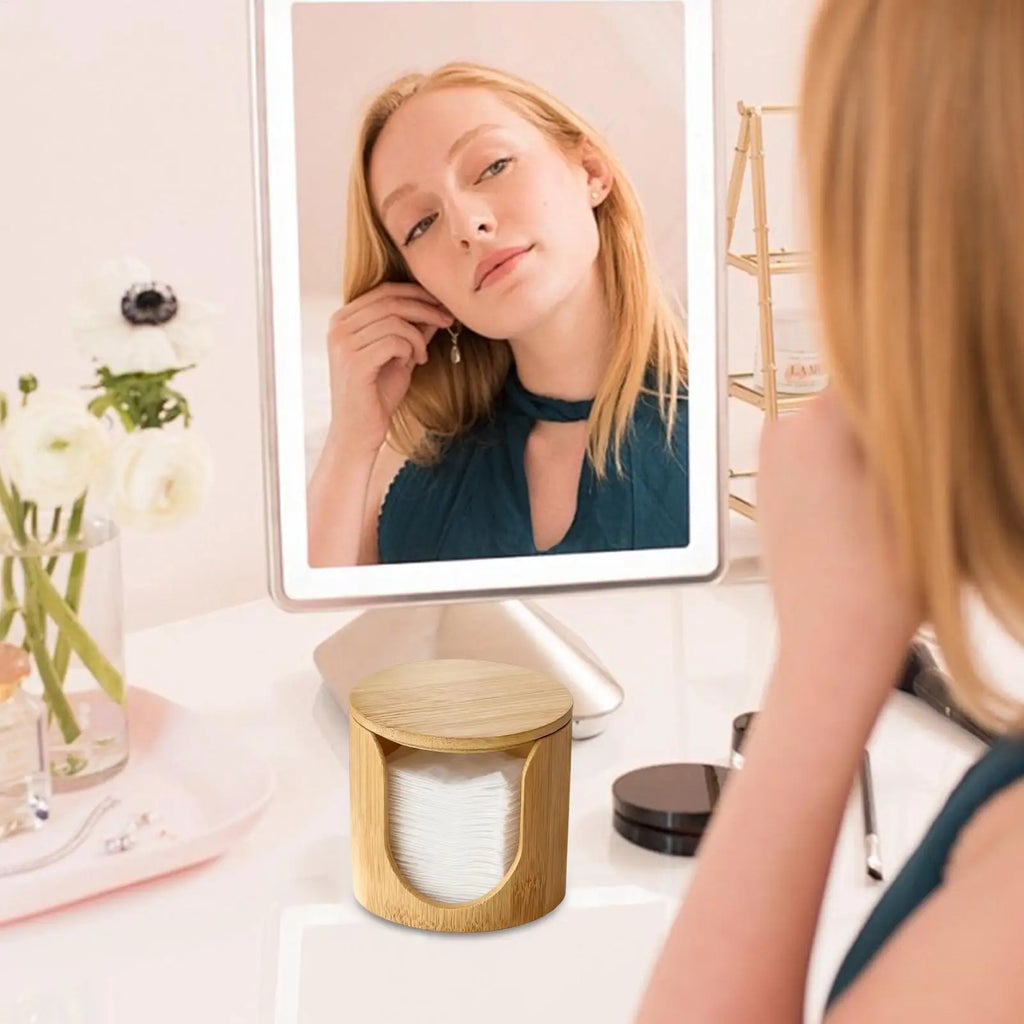 Bamboo cotton pad holder on a vanity table in use during a beauty routine