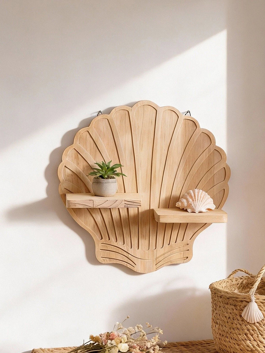 Close-up of the seashell wooden wall shelf displaying a small potted plant and a decorative shell—an example of coastal-inspired shelf styling.