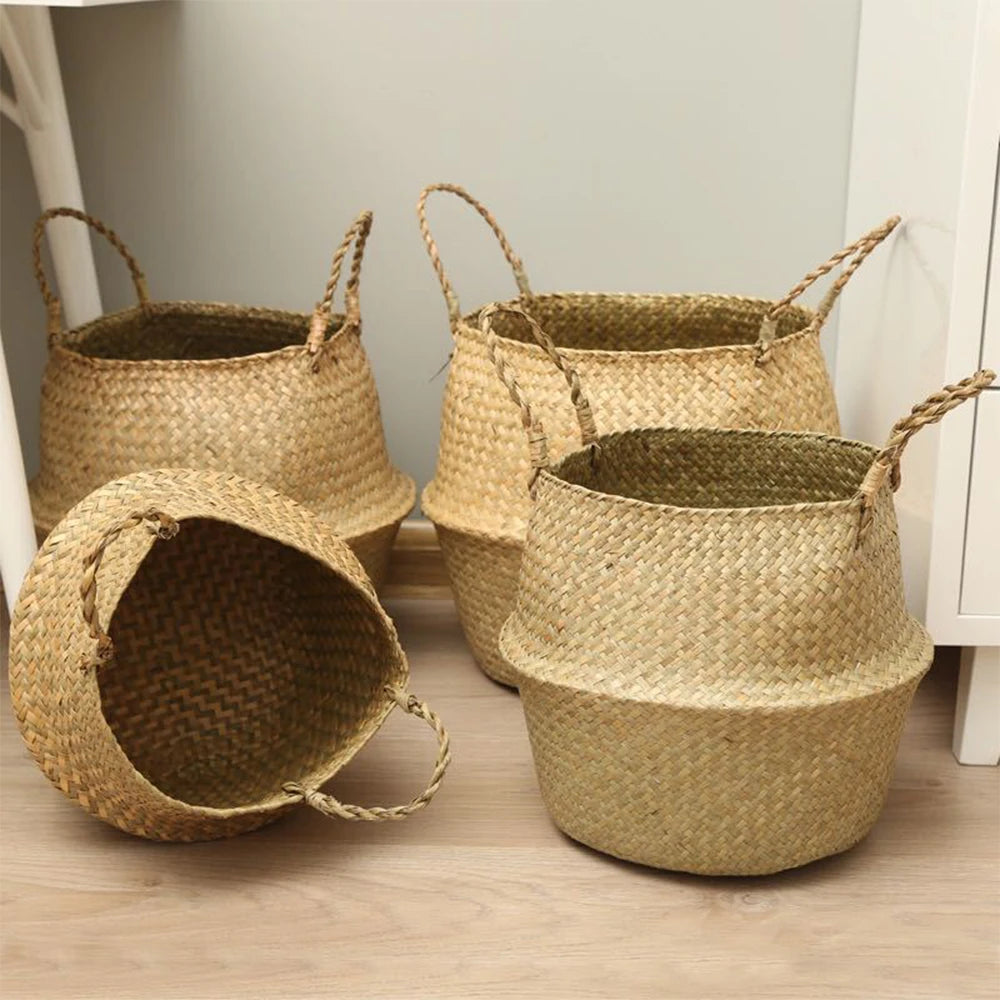 Four empty handwoven seagrass baskets with handles shown on a wood floor, in different sizes