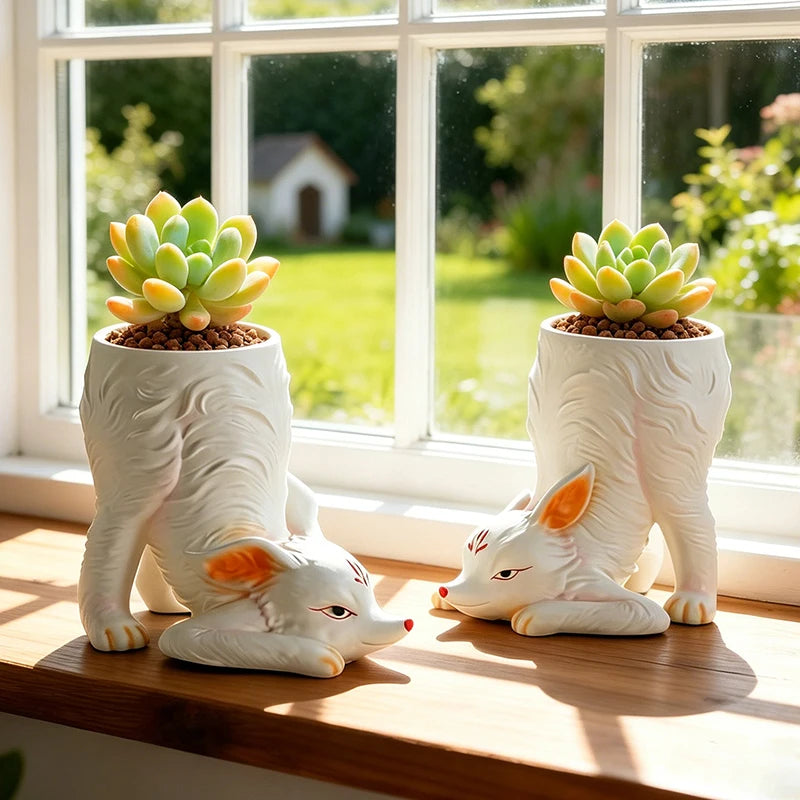 Two nine-tailed fox succulent planters with succulents on a sunny windowsill