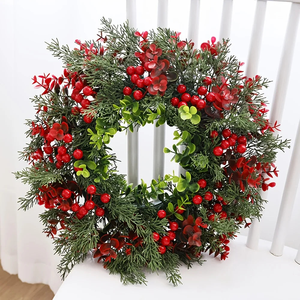Artificial red berry Christmas wreath displayed on chair, vibrant greenery