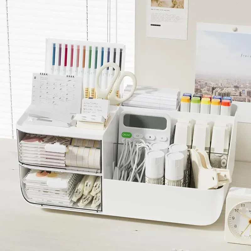 White desk organizer storage box on a home office desk, filled with pens, markers, cables, and notebooks