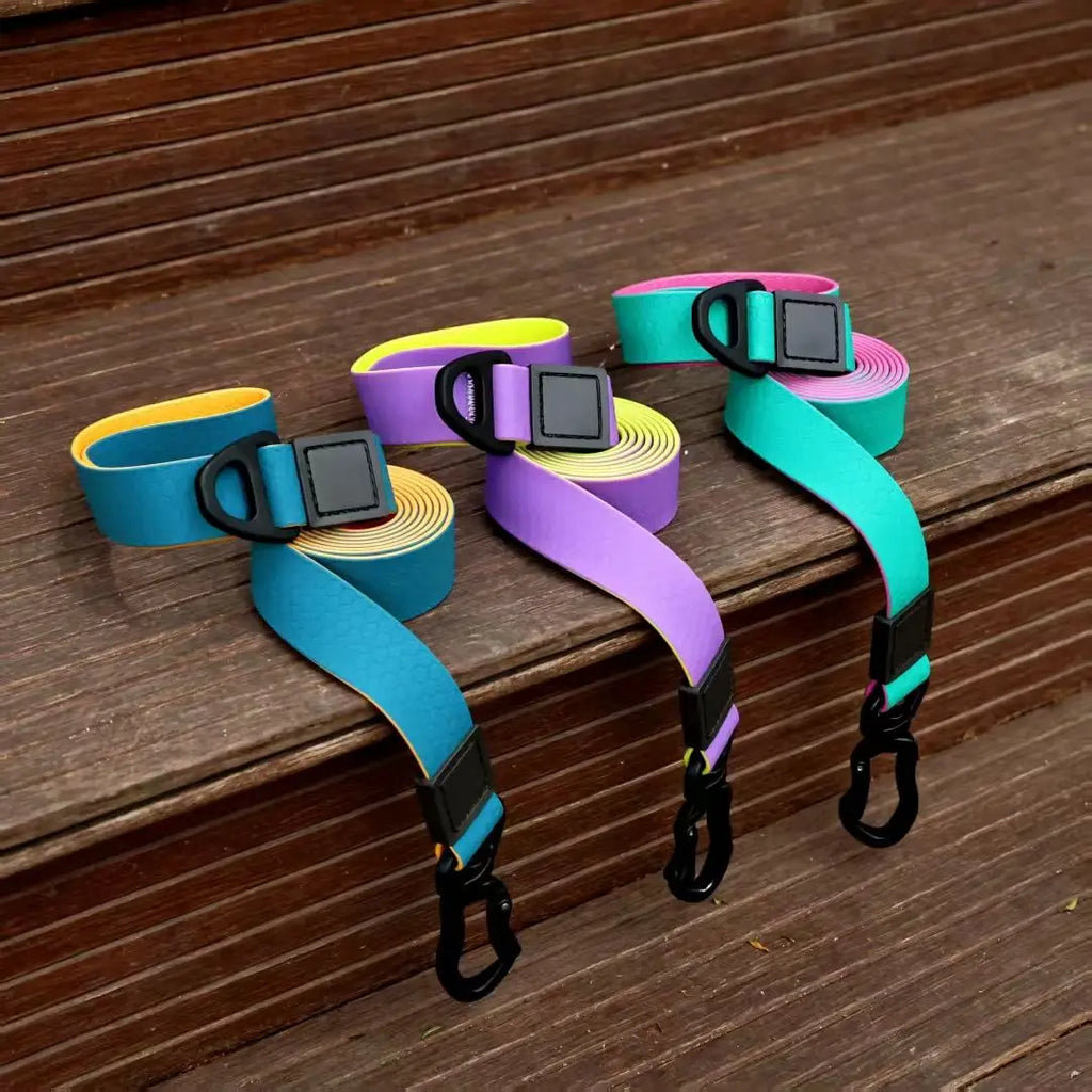 Three waterproof PVC dog leashes in purple/yellow, blue/yellow, and green/purple displayed on outdoor wooden steps