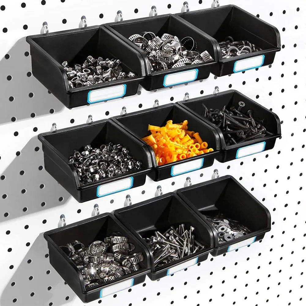 Black plastic pegboard storage bins with labels, attached to a white pegboard wall and filled with various small hardware items