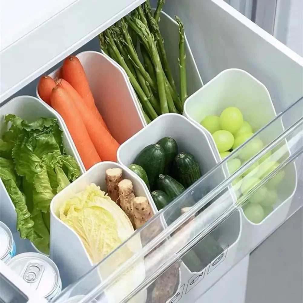 Slim fridge organizer bins holding vegetables and fruit in a refrigerator drawer
