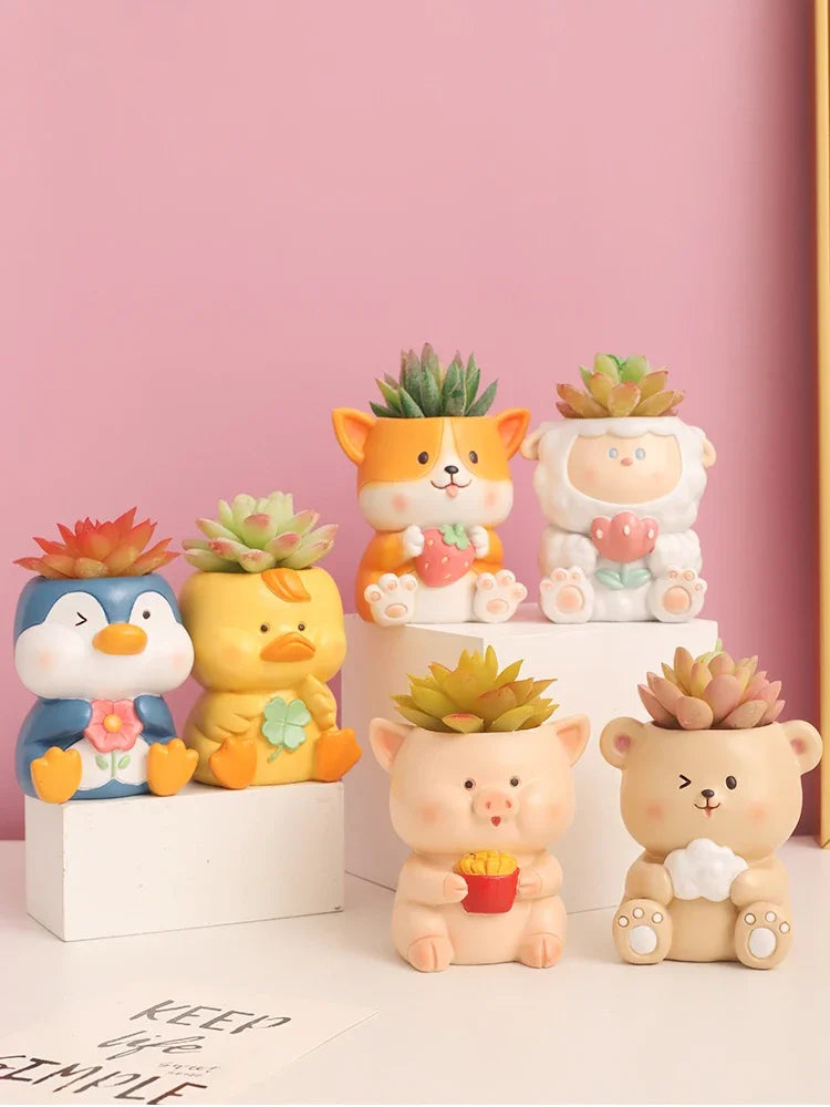 Four styles of animal resin planters with succulents displayed on a pink background