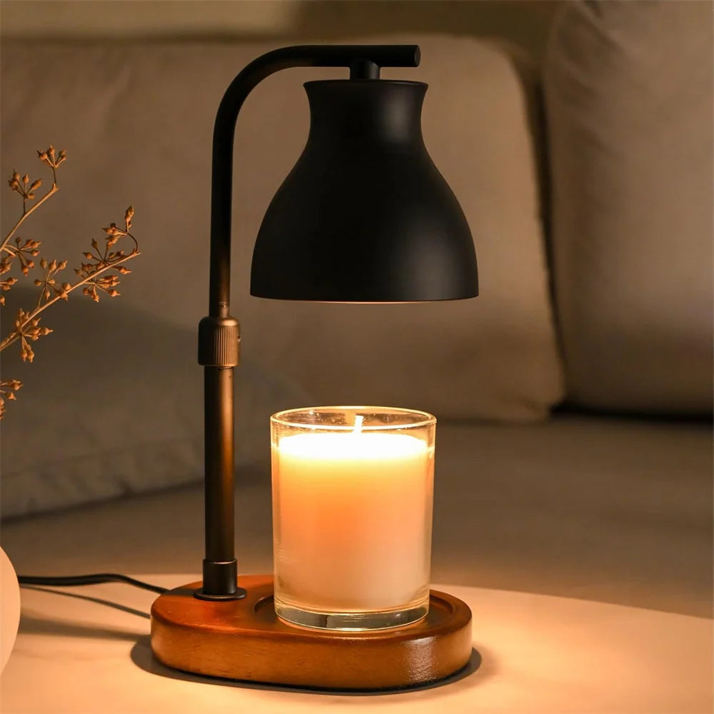 Candle warmer lamp with black shade and wooden base lighting a glass jar candle on a side table