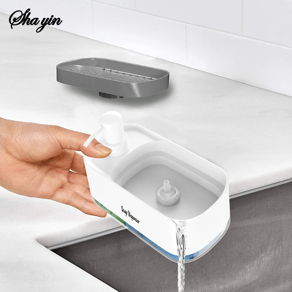 Detail of removable gray sponge tray on white soap dispenser showing empty compartment