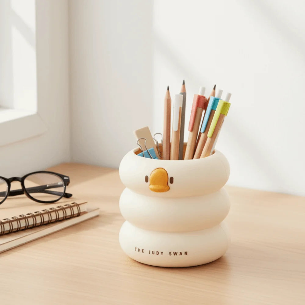 Cream round duck organizer filled with colored pencils on a sunny desk