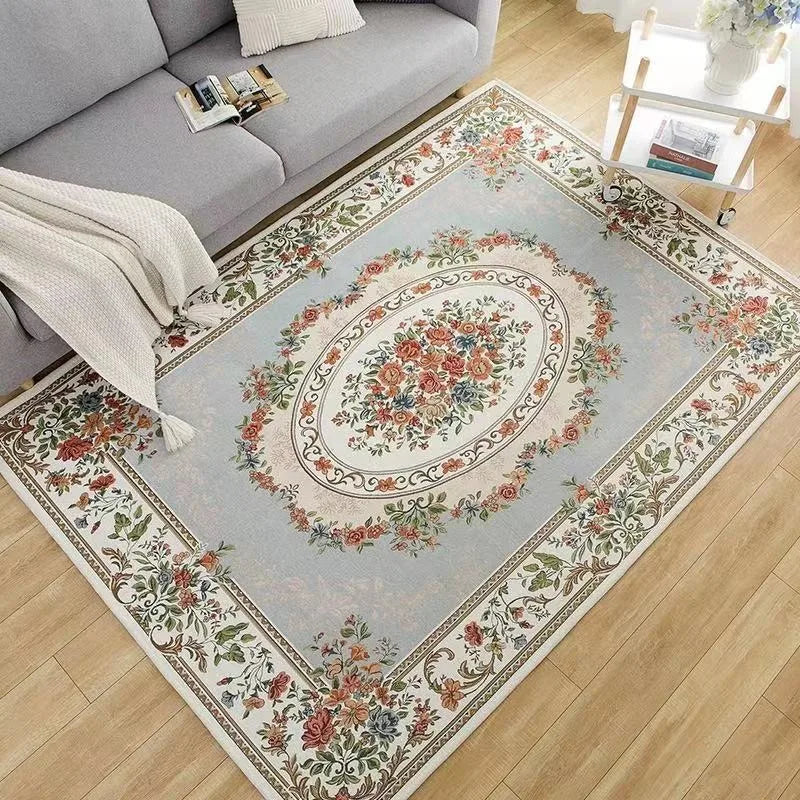 Traditional floral area rug styled under a gray sofa in a living room