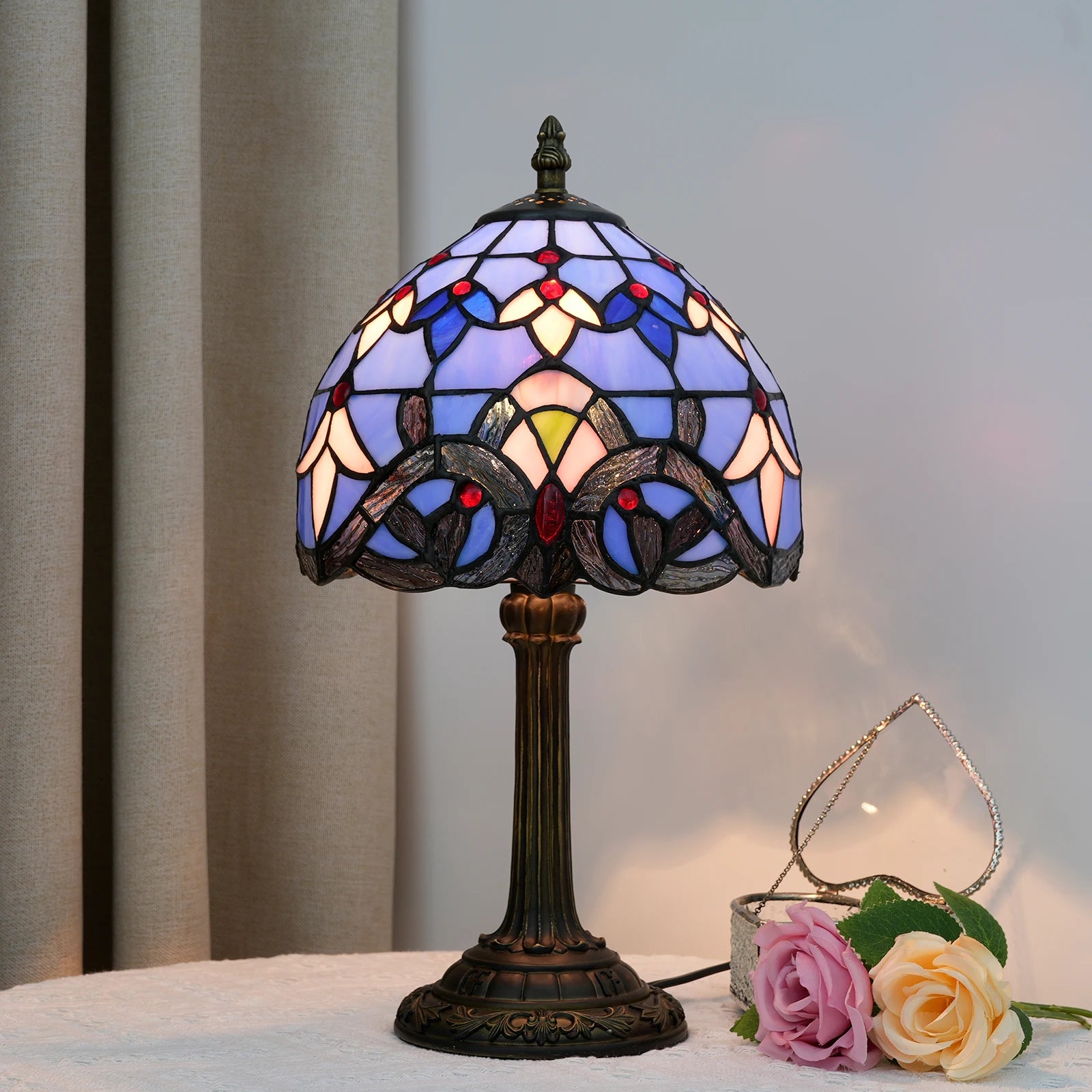 Blue stained glass lamp lit up, creating a cozy atmosphere