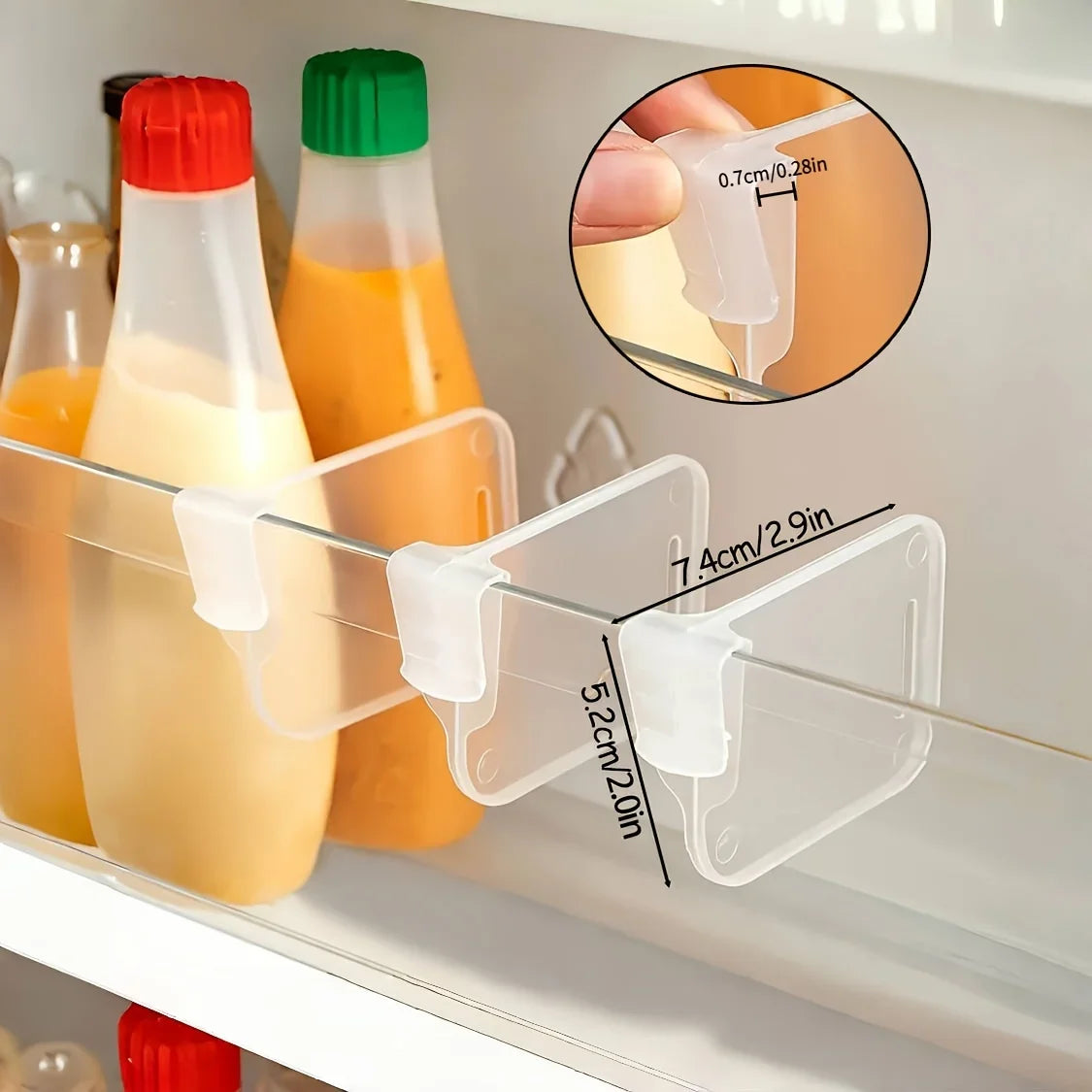 Detail of clear fridge shelf dividers showing clip and dimensions on a fridge shelf