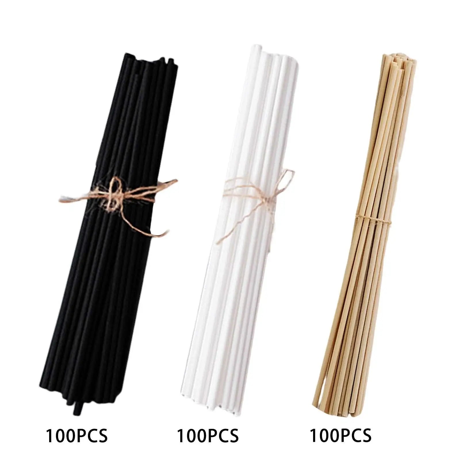 Three bundles of reed diffuser replacement sticks in black, white, and natural colors, each tied with twine