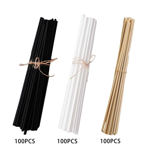 Three bundles of fiber reed diffuser replacement sticks in black, white, and natural colors, each tied with twine, 100 pieces per bundle