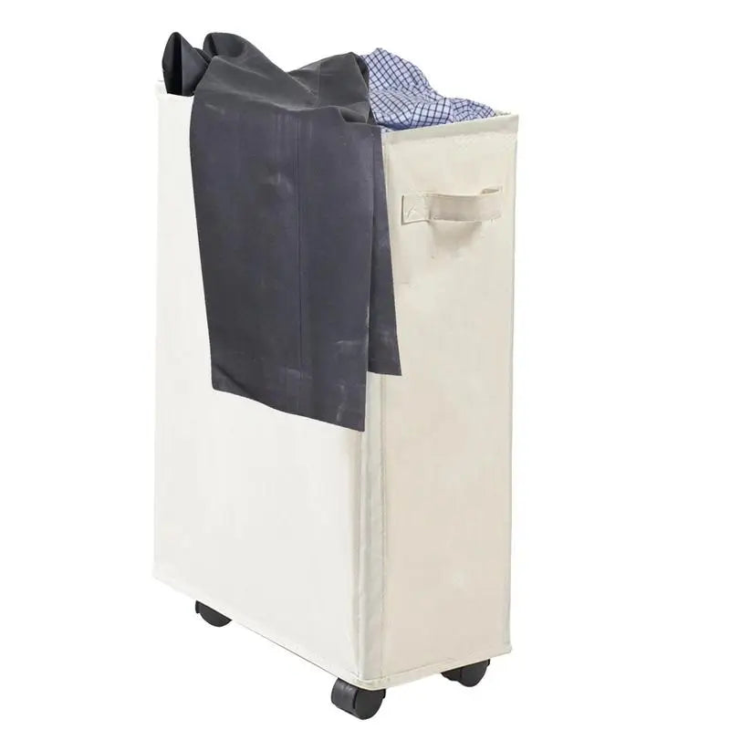 Slim beige rolling laundry hamper with clothes draped over the side, showing handle and wheels