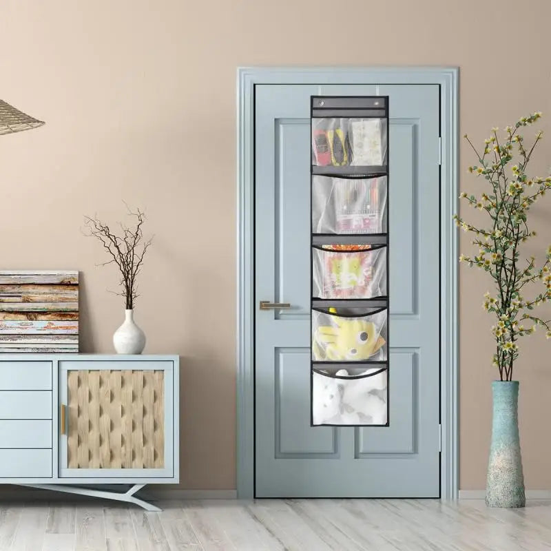 Slim 5-pocket mesh door organizer displayed on a light blue door in a living space, storing soft items and toys