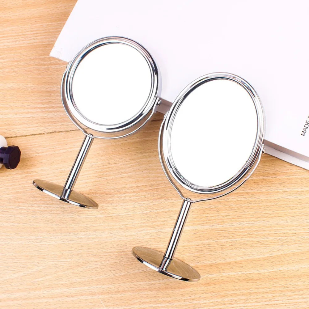 Overhead view of round and oval desktop mirrors on a wood table