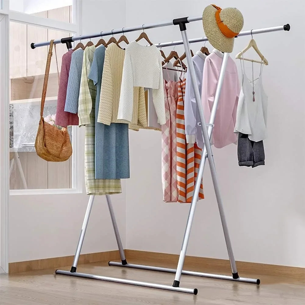 Double rail adjustable clothes drying rack with assorted garments hanging in a bright room