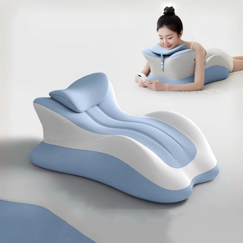 Contoured memory foam wedge pillow in blue and white, used for comfortable reading or phone use on the floor