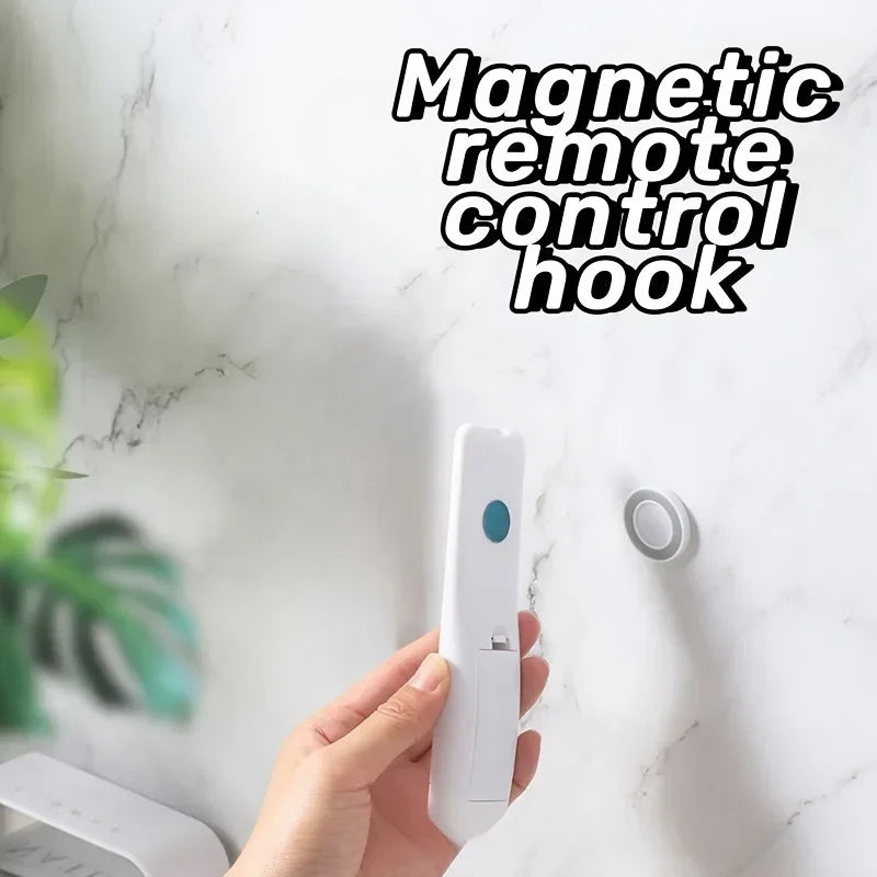 Person holding remote near mounted magnetic holder on marble wall with 'Magnetic remote control hook' text