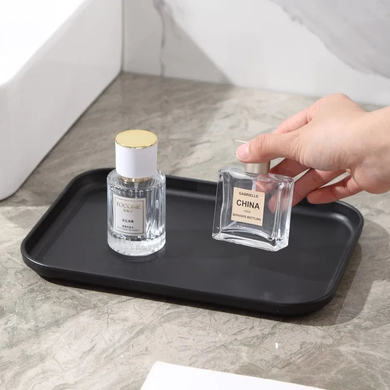 Matte black rectangular tray used to hold two bottles, placed near a sink