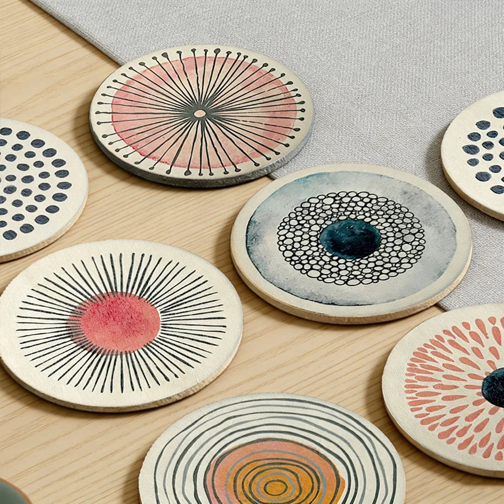 Detailed view of assorted round coasters with modern art patterns on a coffee table