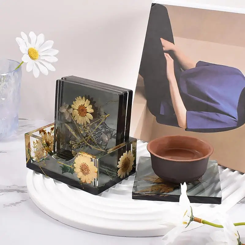 Square resin coaster holder mold and finished coasters in a home decor setting