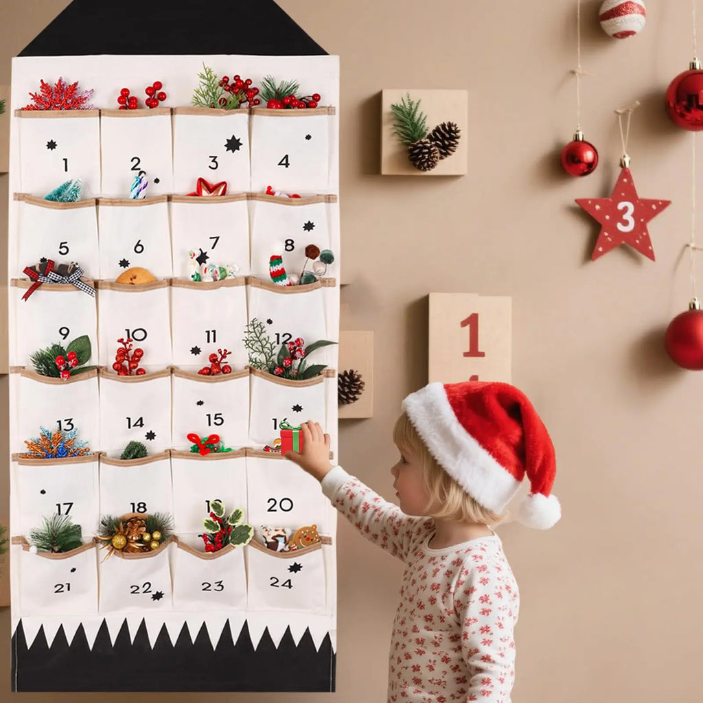 child in festive pajamas selecting a treat from a cloth advent calendar hanging on a living room wall