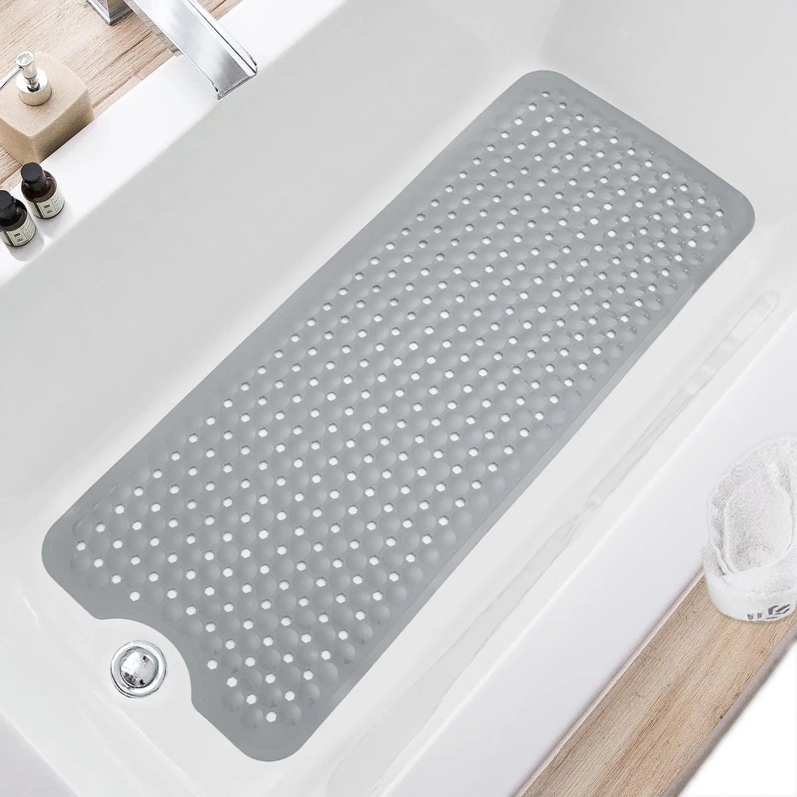 Light grey non-slip bathtub mat with drain holes in a white tub, shown in a modern bathroom setting.