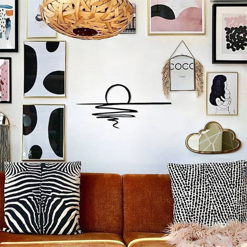 Matte black sunrise wall art displayed with framed modern art above a sofa