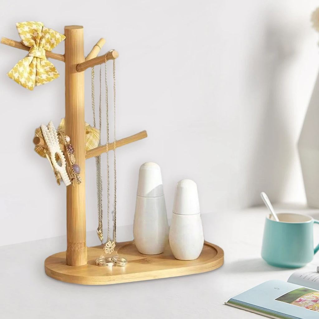 Bamboo mug holder on vanity with jewelry, hair clips, and accessories displayed