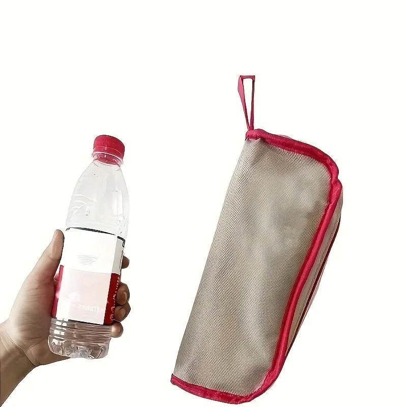 Red-trim folding outdoor stool folded beside a water bottle, showing compact size
