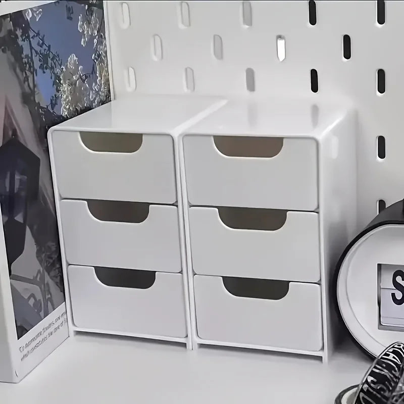 Compact 3-drawer white organizer boxes on a desktop workspace