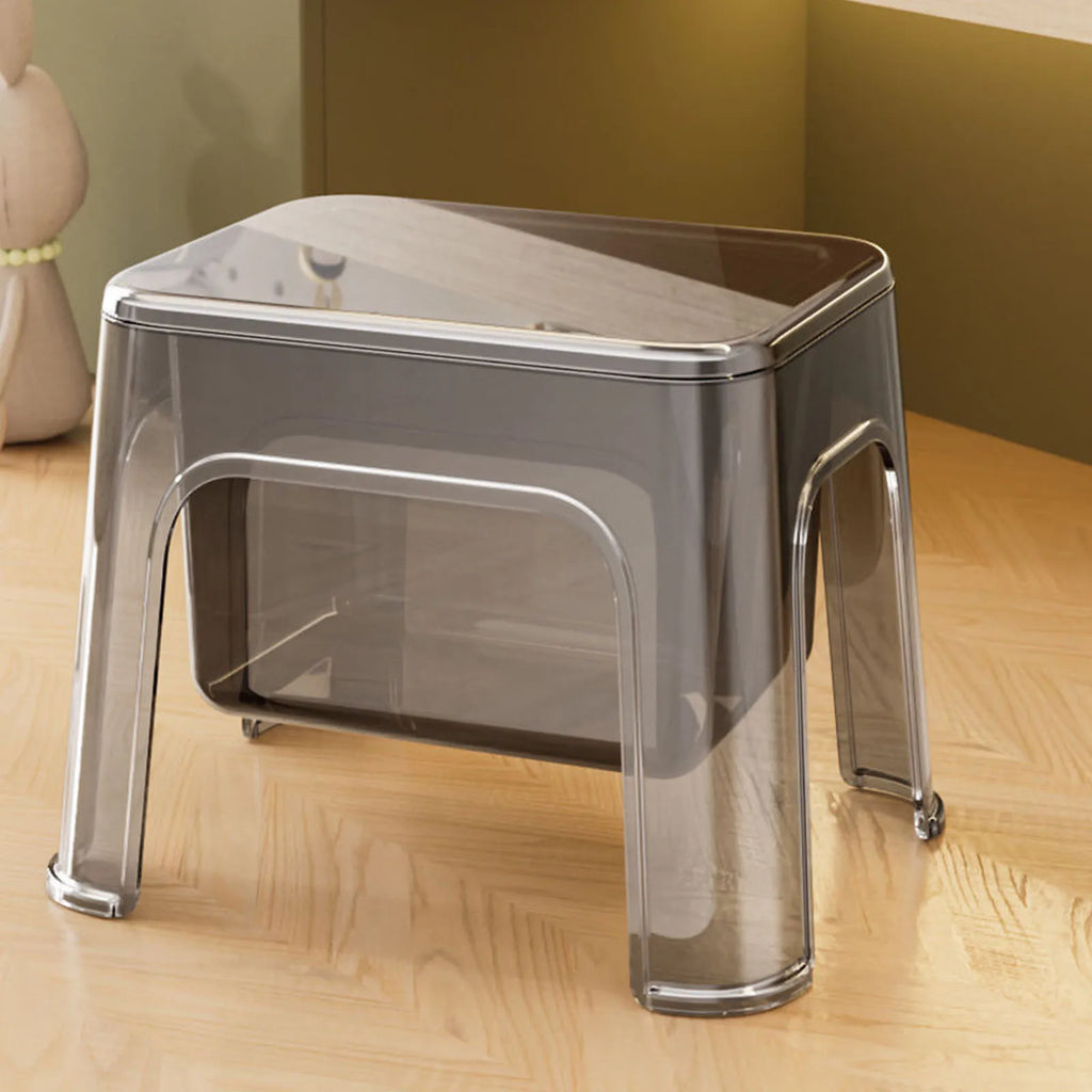 Gray transparent step stool with lid in a home setting on wood floor