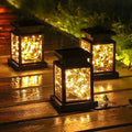 Warm white solar LED lanterns lighting a wooden garden path at night