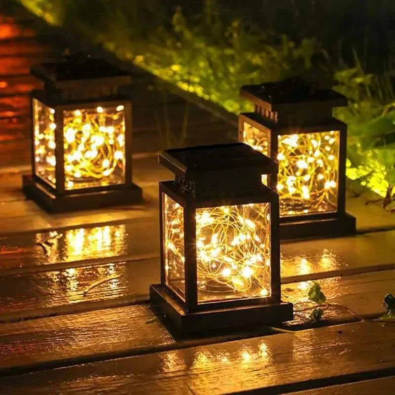 Warm white solar LED lanterns lighting a wooden garden path at night