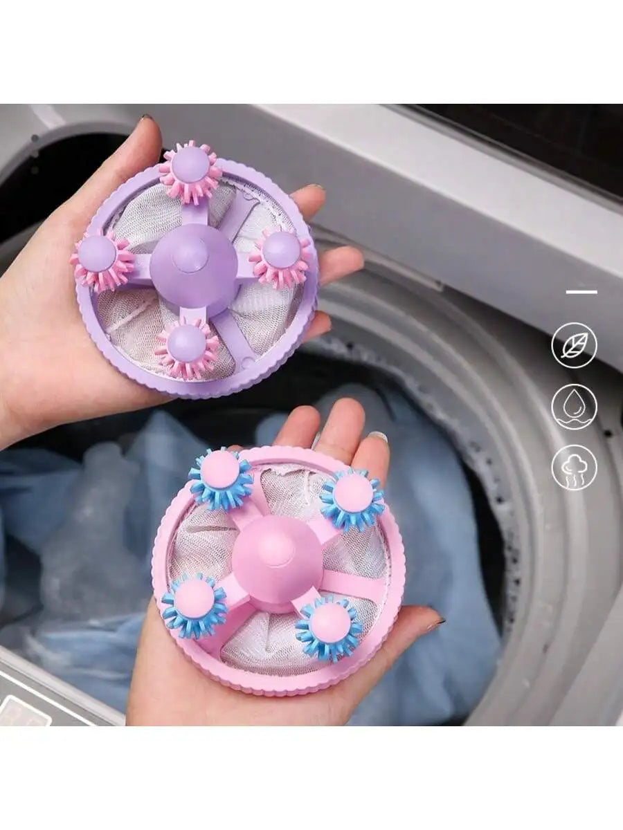 Person holding purple and pink lint catcher balls above laundry in washing machine