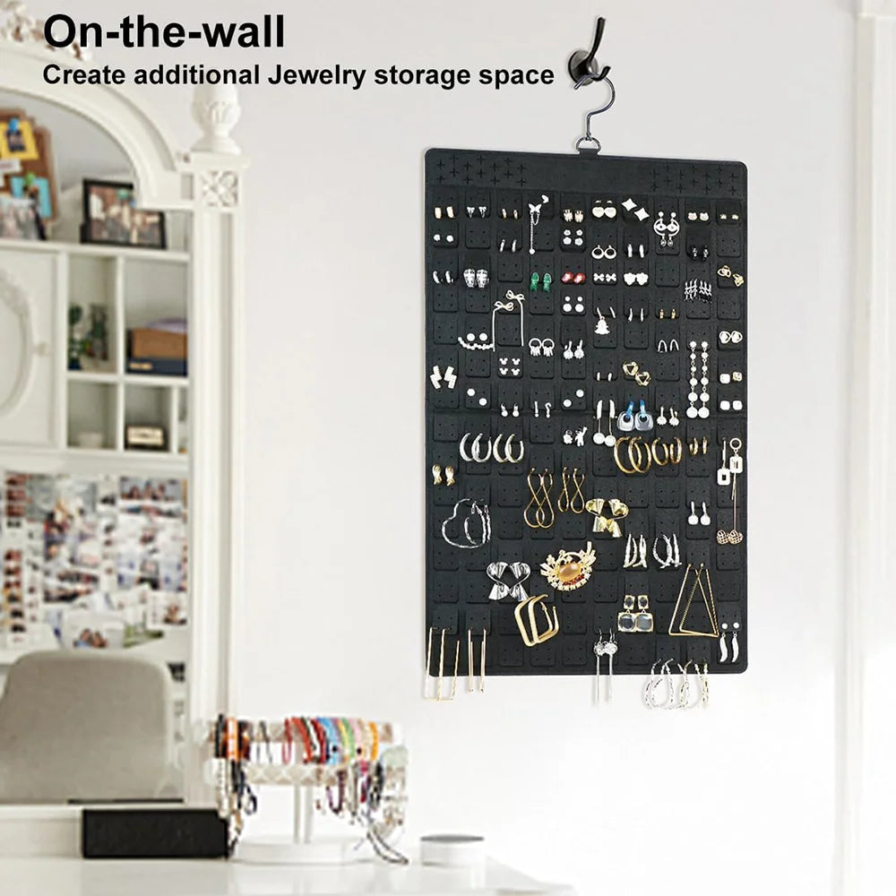 Hanging jewelry organizer displayed on a wall in a bedroom vanity area