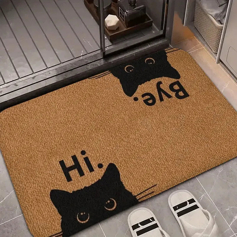 Cat themed doormat with slippers at a bathroom entrance